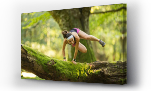 Wizualizacja Obrazu : #440139091 Confident woman jumping over fallen tree in forest