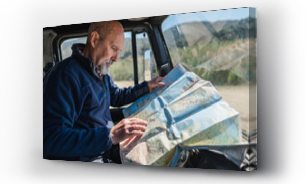 Wizualizacja Obrazu : #442670126 Concentrated travelling man reading map in car