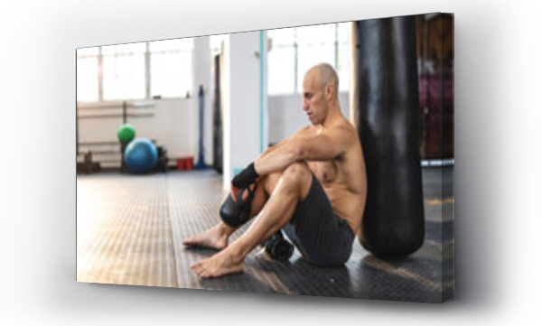 Wizualizacja Obrazu : #447680111 Strong caucasian man exercising at gym, having a rest