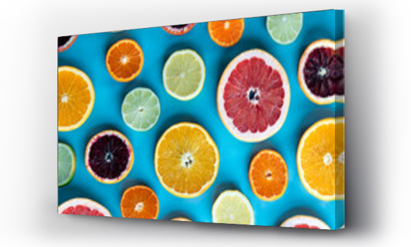 Wizualizacja Obrazu : #457415480 Colorful slices of various citrus fruit on a blue background.