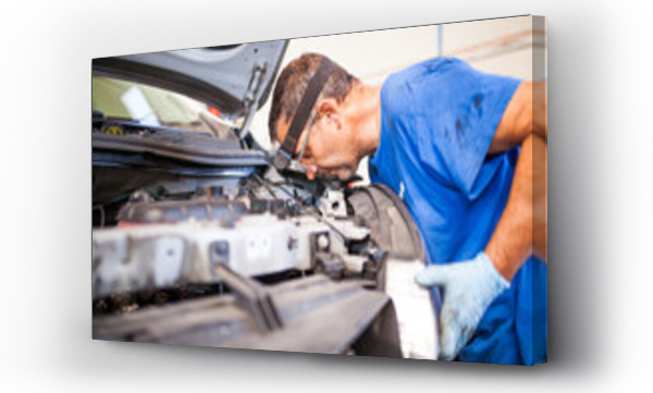 Wizualizacja Obrazu : #459710836 Male mechanic repairing automobile in workshop