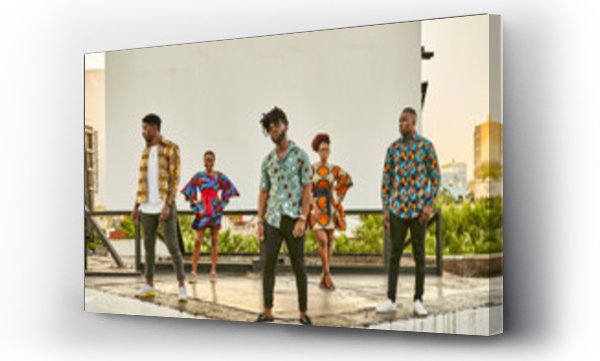 Wizualizacja Obrazu : #462733024 Friends in colorful clothes standing on roof terrace in the city, Maputo, Mozambique