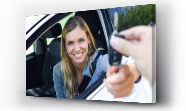 Wizualizacja Obrazu : #462757742 Portrait of smiling young woman looking at camera while holding car keys and give it to someone through the window