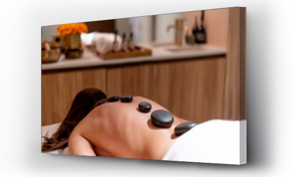 Wizualizacja Obrazu : #462855365 Young woman lying with stones on her back during lastone therapy at health spa