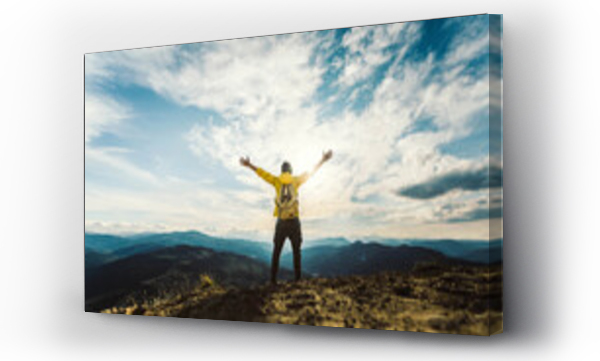 Wizualizacja Obrazu : #464726063 Man traveler on mountain summit enjoying nature view with hands raised over clouds - Sport, travel business and success, leadership and achievement concept