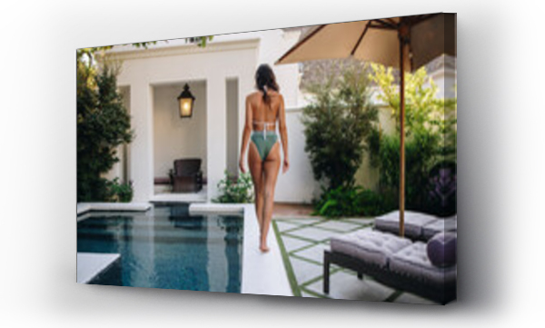 Wizualizacja Obrazu : #466419256 Back view of a woman walking in a bikini at a spa