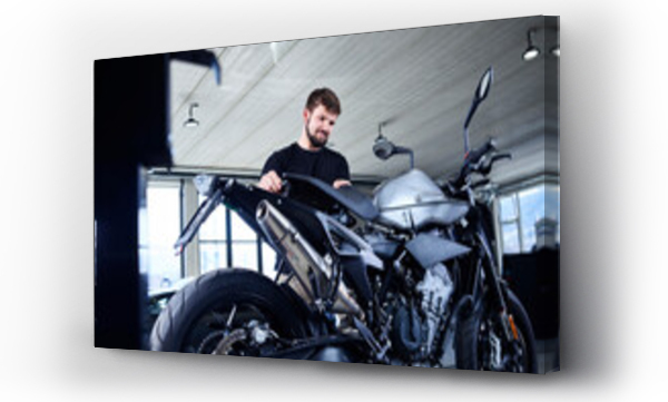 Wizualizacja Obrazu : #473995210 Young male mechanic repairing motorcycle at repair shop