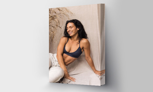 Wizualizacja Obrazu : #486613492 Woman in cozy sweatpants and sport bra smiling