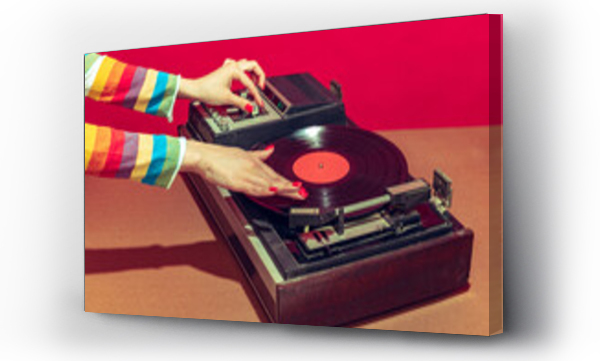 Wizualizacja Obrazu : #502572262 Colorful image of female hands spinning retro vinyl record player like a dj isolated over red background