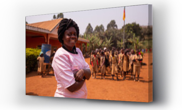 Wizualizacja Obrazu : #504642824 Portrait of an african school teacher with the pupils in the background out of focus, education in africa concept