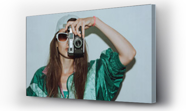 Wizualizacja Obrazu : #514998338 Cool teenager. Fashionable girl in colorful trendy jacket and vintage retro sunglasses with camera film in 80s - 90s style. Teenage girl at the disco, on a white background.