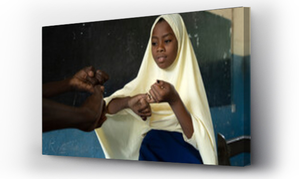 Wizualizacja Obrazu : #518455682 School girl with a hearing disability, learning sign language.