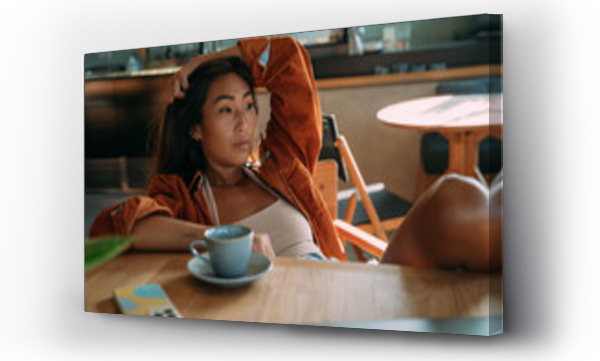 Wizualizacja Obrazu : #532621703 Asian woman taking break at a restaurant with cup of coffee