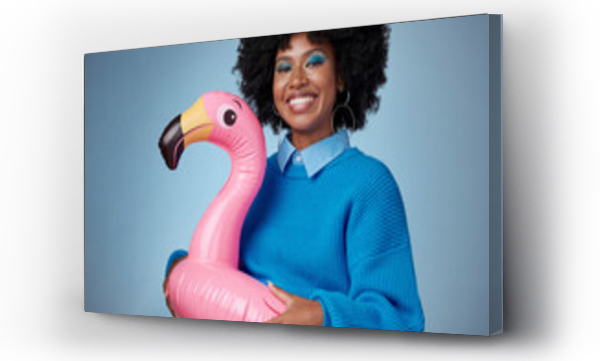 Wizualizacja Obrazu : #535830522 Portrait of woman in blue with a flamingo and a smile on her face. Happy black woman with inflatable bird rubber ring on hip on blue background. Mockup for trendy, travel and fun for summer vacation