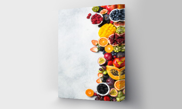 Wizualizacja Obrazu : #538024532 Healthy raw rainbow fruits background, mango papaya strawberries oranges passion fruits berries on oval serving plate on light kitchen top, top view, copy space, selective focus