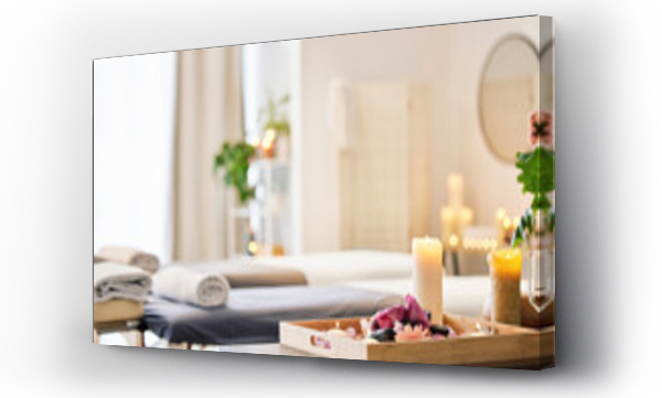 Wizualizacja Obrazu : #546468165 Candle, spa and relax with aromatherapy treatment in a tray in a room for luxury or wellness. Background, health and massage with still life in an empty resort for peace, skincare or relaxation