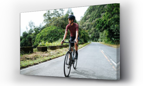 Wizualizacja Obrazu : #555583467 A young female cyclist riding her gravel bike in the mountains.