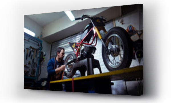 Wizualizacja Obrazu : #559112829 Low angle view of engineer repairing motorcycle at garage