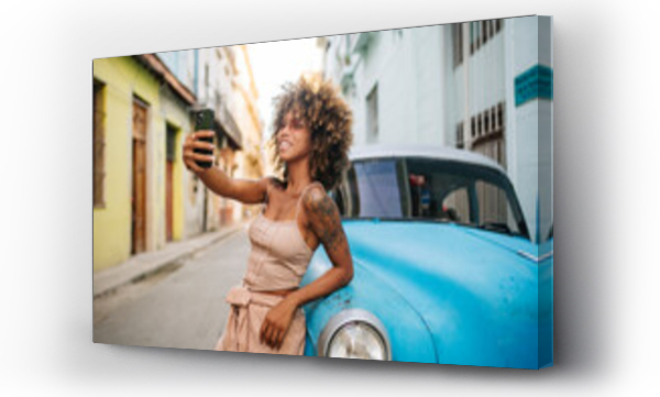 Wizualizacja Obrazu : #568973827 Cuban woman taking selfie near retro car