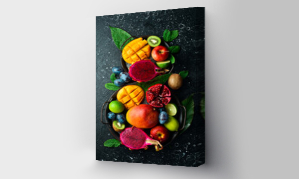 Wizualizacja Obrazu : #571947529 Background of exotic fruits. Ripe tropical fruits on a stone background. Copy space. Top view.