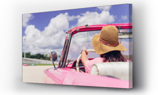 Wizualizacja Obrazu : #575403466 Anonymous female traveler in straw hat driving pink retro cabriolet on cloudy day during summer vacation in Cuba. Unrecognizable woman driving retro cabriolet on city road