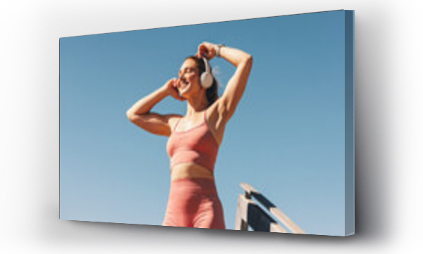 Wizualizacja Obrazu : #578943121 Caucasian sports woman listening to music on headphones outdoors