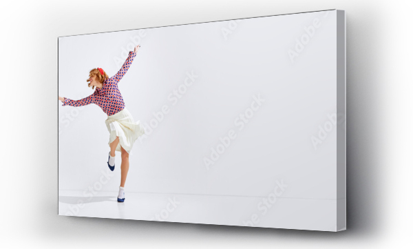 Wizualizacja Obrazu : #581762813 Happy young man and woman in stylish clothes emotionally dancing retro dance against grey studio background. Concept of art, retro style, hobby, party, fun, movements, 60s, 70s culture. Banner