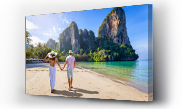 Wizualizacja Obrazu : #582053921 A happy couple on holidays walks down the empty Railay Beach at Krabi, Thailand, with emerald sea and lush rain forest