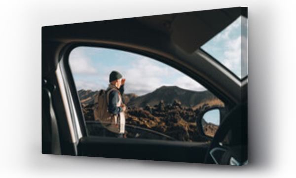 Wizualizacja Obrazu : #603088506 Young Man explores lava valley, mountain volcano from car at road trip