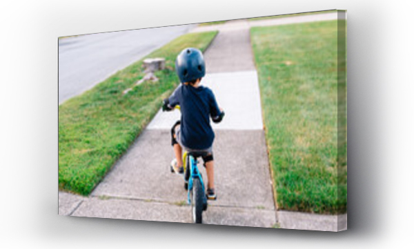 Wizualizacja Obrazu : #620678618 Young boy rides bike down sidewalk