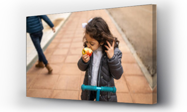 Wizualizacja Obrazu : #620729173 little girl eating fruit on the street