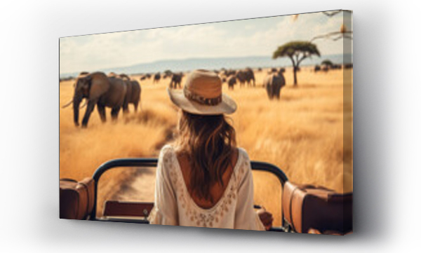 Wizualizacja Obrazu : #630087530 woman standing in a safari vehicle tourist elephant in the savanna travel summer
