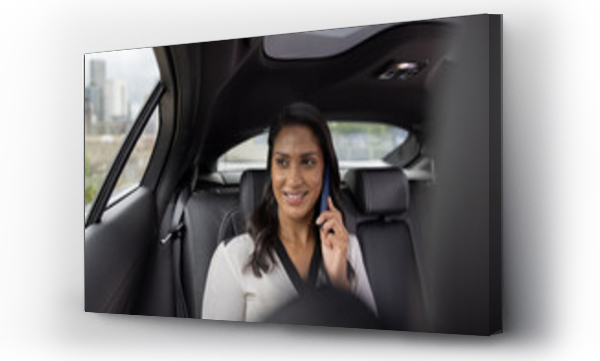 Wizualizacja Obrazu : #630340688 Businesswoman looking out of window in executive car on a phonecall