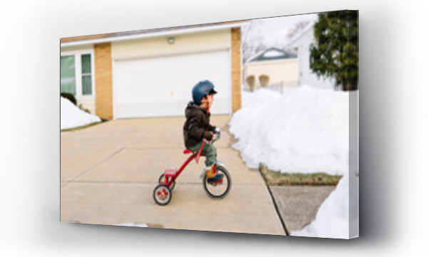 Wizualizacja Obrazu : #636056820 Child rides bike down snowy sidewalk