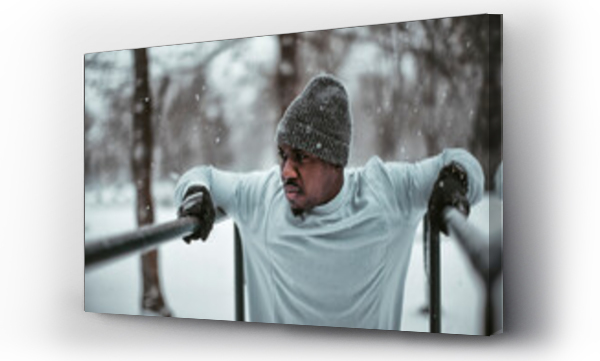 Wizualizacja Obrazu : #640394180 Young athletic and fit african man exercising and working out in a outdoors park during winter and snow