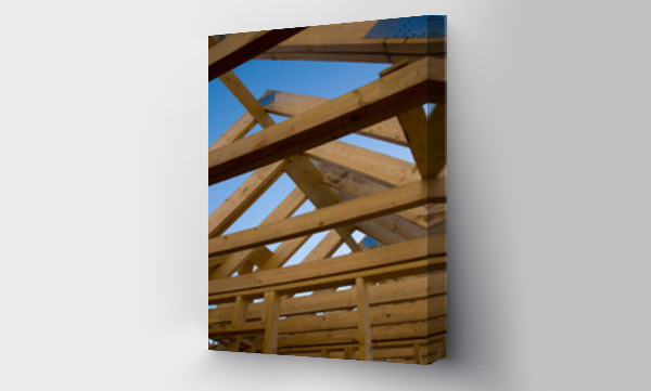 Wizualizacja Obrazu : #642004768 Roof beams of house under construction against blue sky
