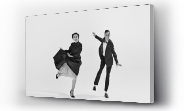 Wizualizacja Obrazu : #652237138 Black and white. Happy, positive, smiling young people, man and woman in elegant clothes dancing lindy hop. Concept of hobby, retro dance, vintage style, choreography, beauty. Monochrome art. Ad