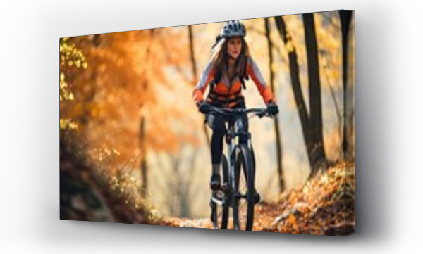Wizualizacja Obrazu : #655088869 Woman riding a mountain bike rides a bicycle in a mountain forest with colorful leaves.