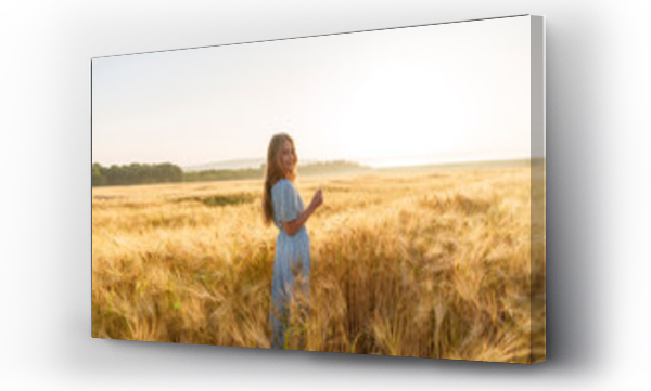 Wizualizacja Obrazu : #656934457 Smiling girl with long hair standing amidst wheat crop in field
