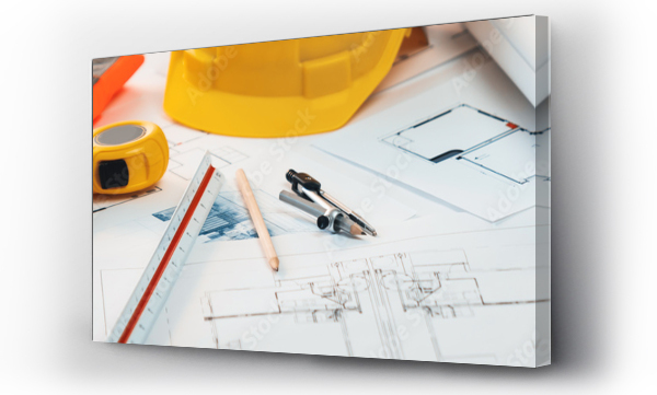 Wizualizacja Obrazu : #659775721 Architectural designed building blueprint layout and engineer tool for designing blueprint with contractor project document on engineer workspace table in office with safety helmet or hardhat. Insight