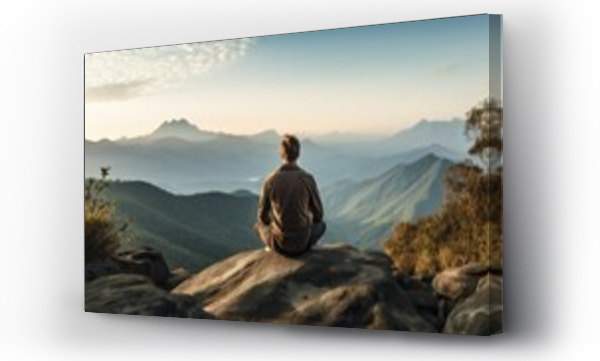 Wizualizacja Obrazu : #661946270 A person sits on a rocky cliff, gazing at a distant mountain range. The serene landscape inspires contemplation and reflection. A peaceful and majestic view that evokes tranquility and wanderlust.