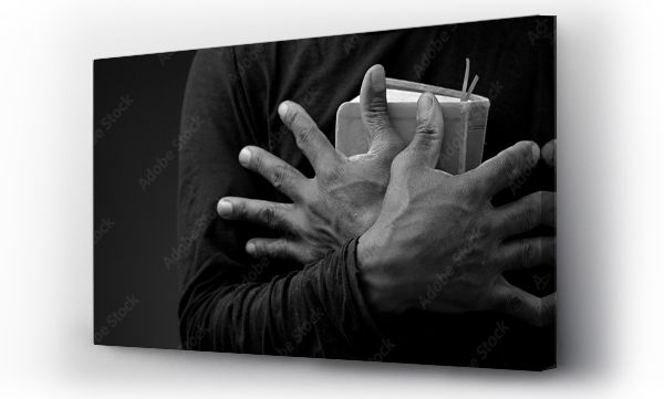 Wizualizacja Obrazu : #665943487 man praying to God with the bible on black background with people stock image stock photo	