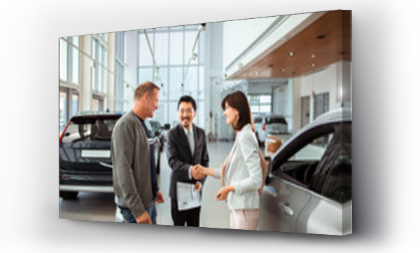 Wizualizacja Obrazu : #670168060 Couple finalizing a car purchase with a dealership representative