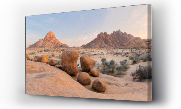 Wizualizacja Obrazu : #670386972 Panoramic, desert landscape of famous rounded red, granite rocks of Spitzkoppe area in early sunrise against blue sky. Picturesque rocky desert photo in calm morning in Spitzkoppe, Namibia.