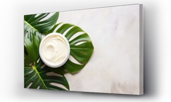 Wizualizacja Obrazu : #671663473 Top view of monstera tropical plant leaves on a marble background, showcasing natural organic cosmetic products. Promotes skin care and beauty treatment.