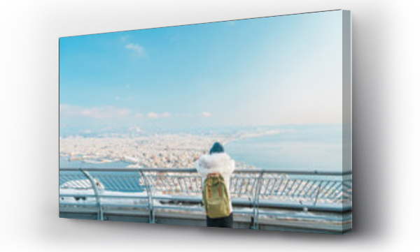 Wizualizacja Obrazu : #673572155 Woman tourist Visiting in Hakodate, Traveler in Sweater sightseeing view from Hakodate mountain with Snow in winter. landmark and popular for attractions in Hokkaido, Japan.Travel and Vacation concept