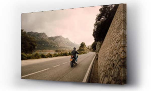 Wizualizacja Obrazu : #686538796 Man riding motorcycle on road in front of mountains aganist sky