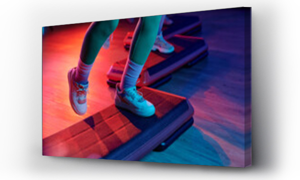 Wizualizacja Obrazu : #688068142 Unknown sportsperson exercising on step platform at gym with other people training on background