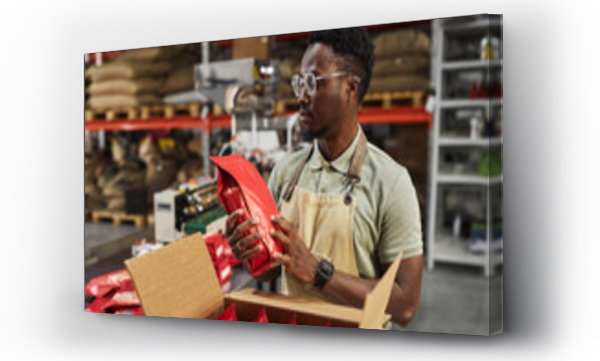 Wizualizacja Obrazu : #689307242 Waist up portrait of Black young man holding coffee bag doing quality control in packaging department, copy space