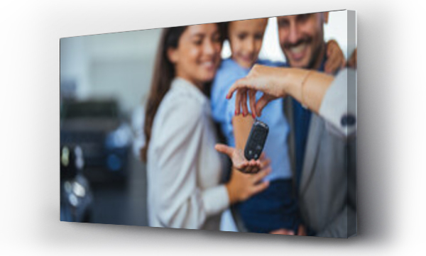 Wizualizacja Obrazu : #691169291 Happy parents with small kid after receiving keys for their new car in a showroom. Congratulations, we have a deal about buying a car! Happy family came to an agreement with a car salesperson